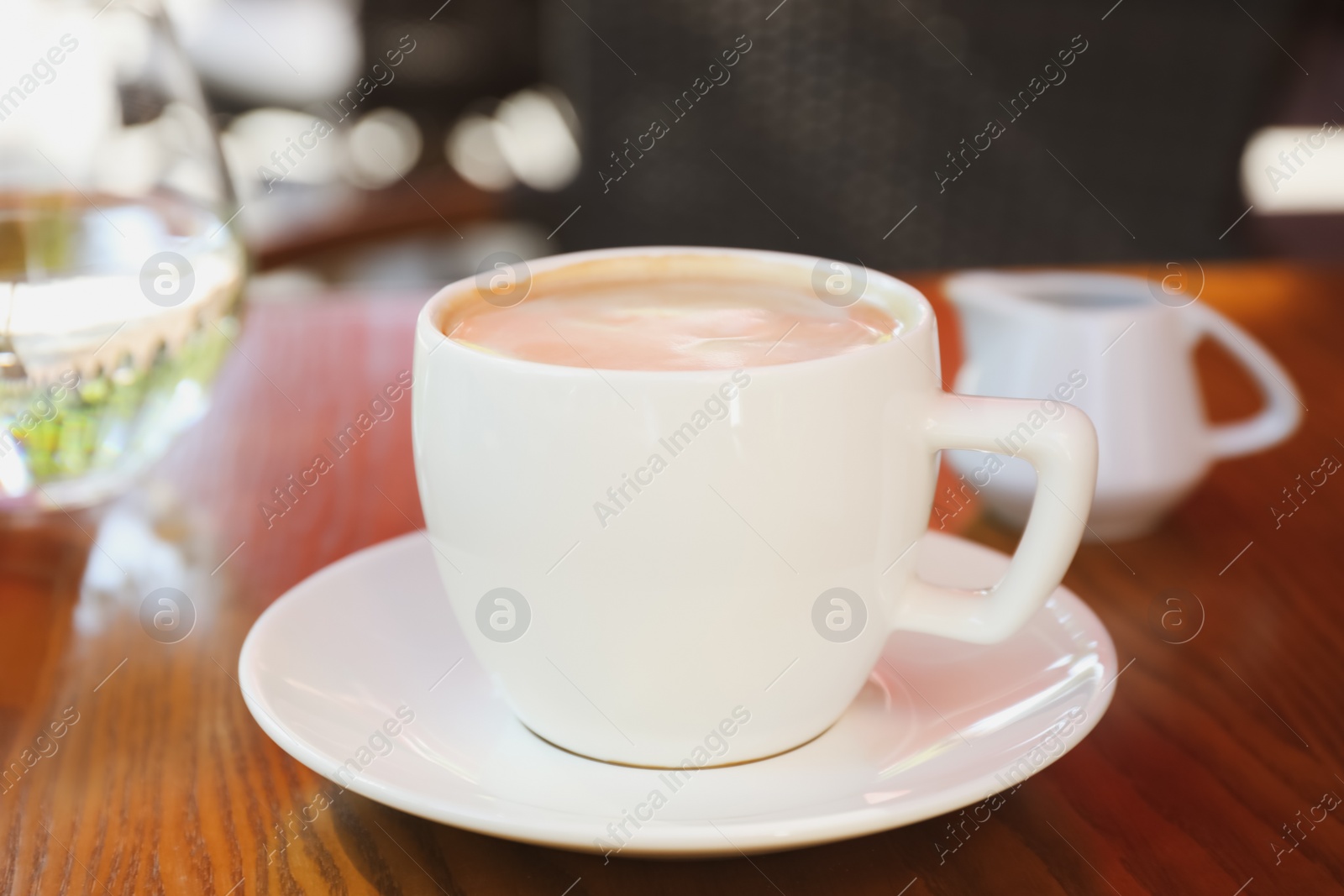 Photo of Aromatic coffee on wooden table outdoors, closeup