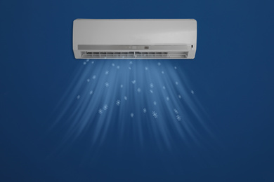 Image of Modern air conditioner on blue wall indoors