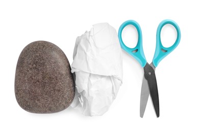 Photo of Rock, crumpled paper and scissors on white background, top view