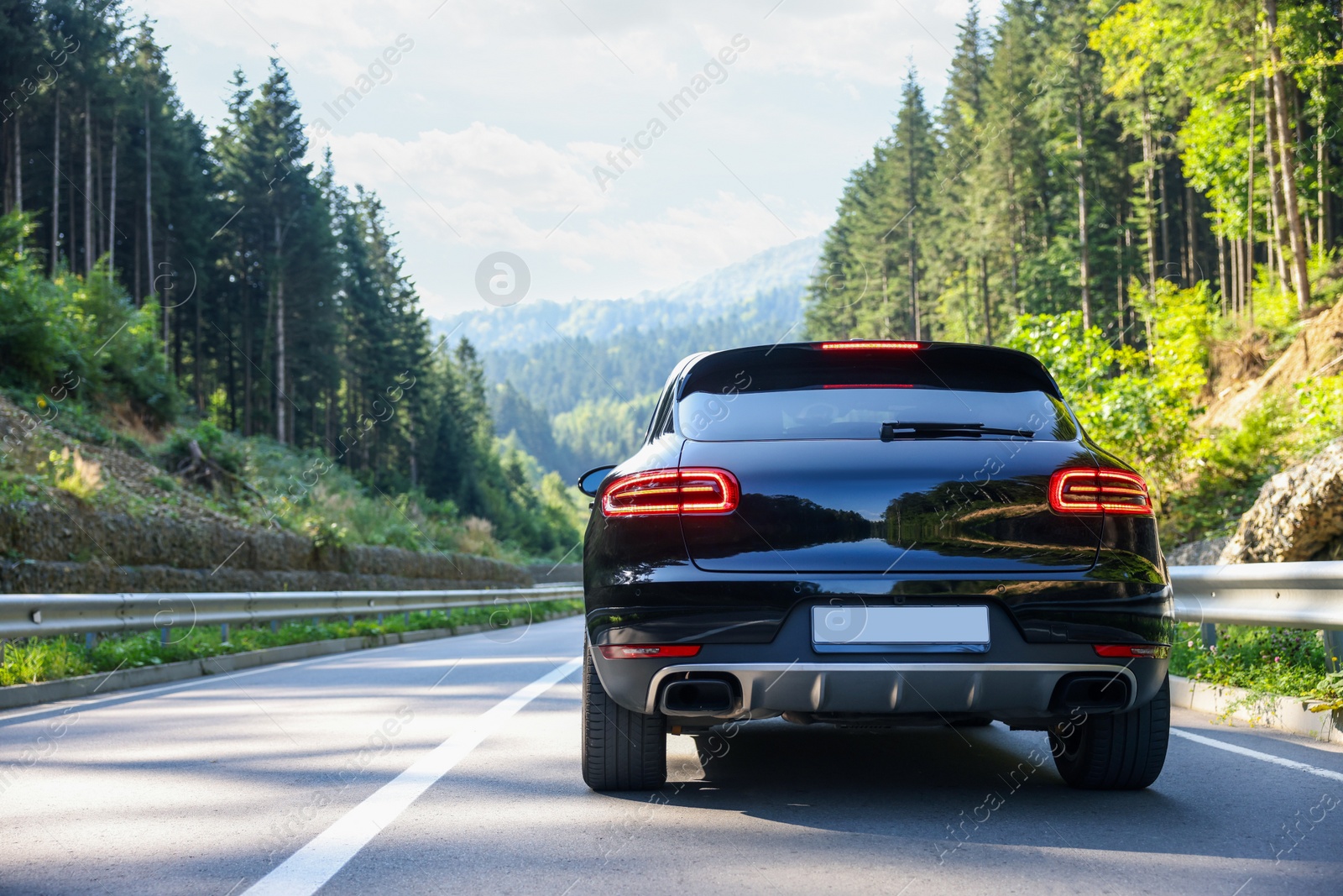 Photo of Picturesque view of asphalt road with modern car