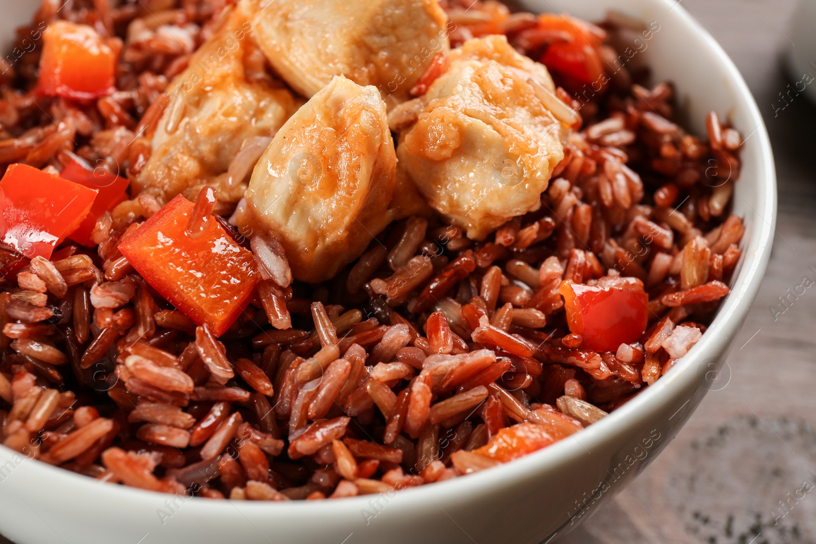 Photo of Delicious brown rice in bowl, closeup view