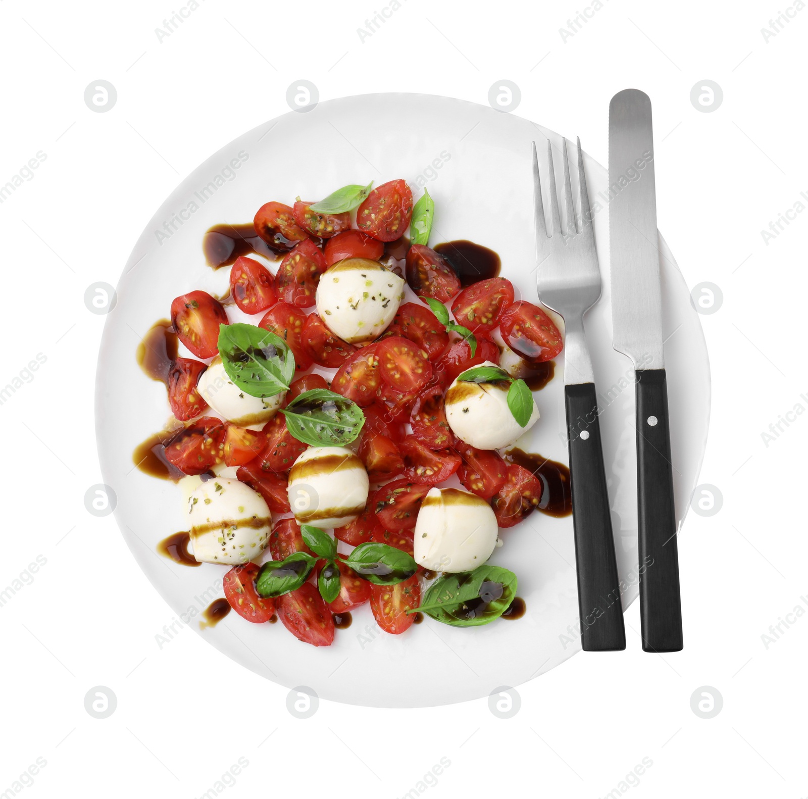 Photo of Tasty salad Caprese with tomatoes, mozzarella balls, basil and cutlery on white background, top view