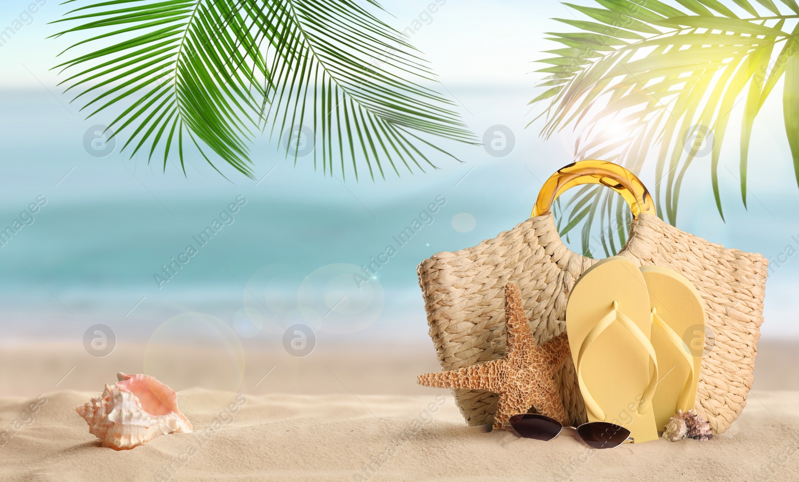 Image of Summer vacation. Bag with accessories on sunny ocean beach, space for text. Banner design