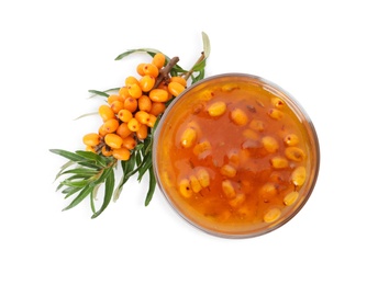 Delicious sea buckthorn jam in bowl and fresh berries on white background, top view