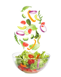 Image of Fresh ingredients for tasty salad falling into bowl on white background