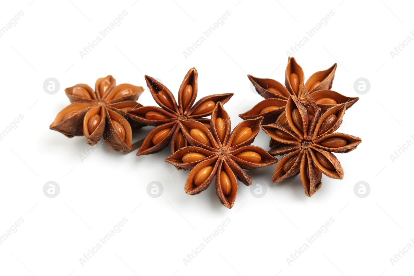 Photo of Dry anise stars with seeds on white background