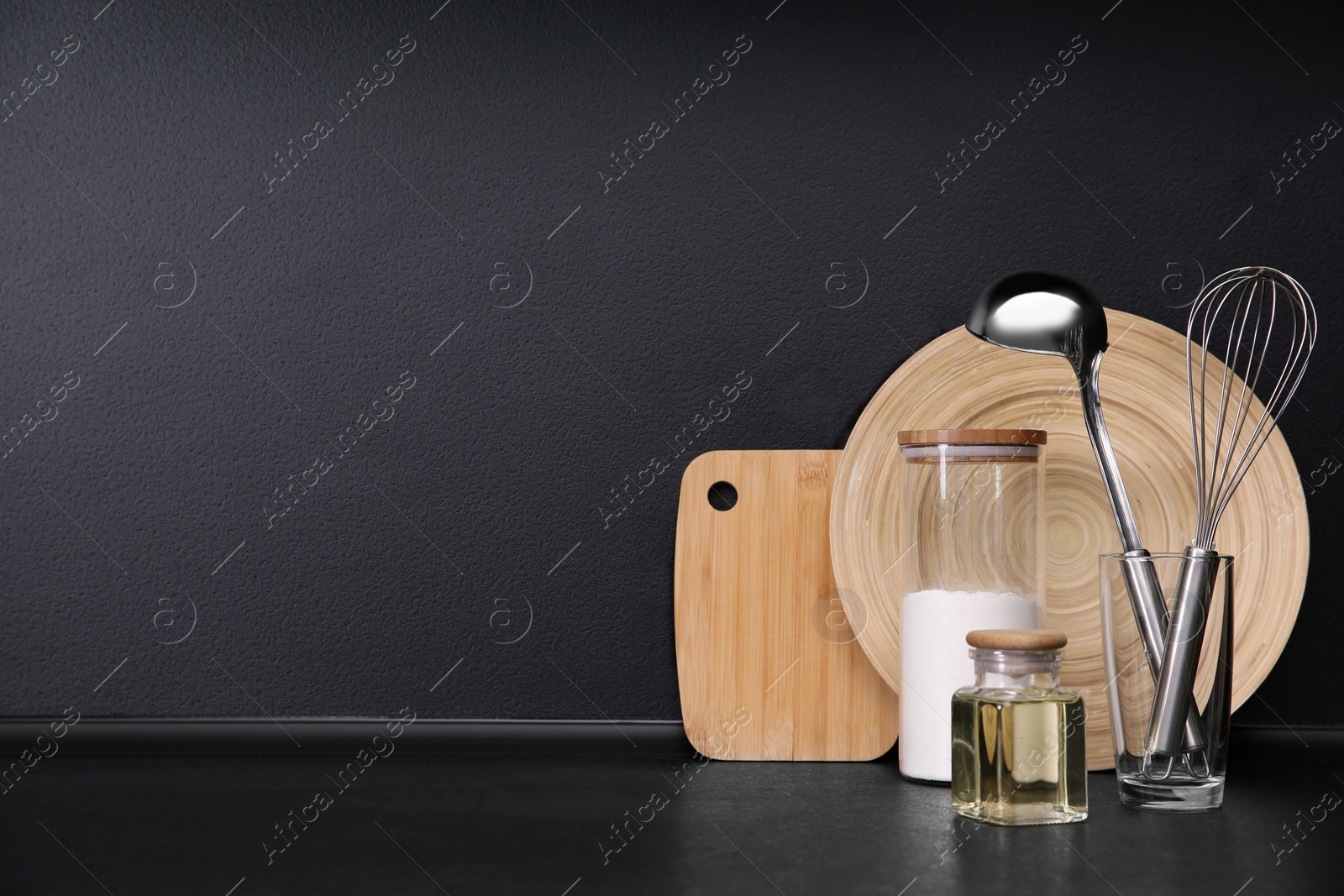 Photo of Composition with kitchenware on table against grey background. Space for text