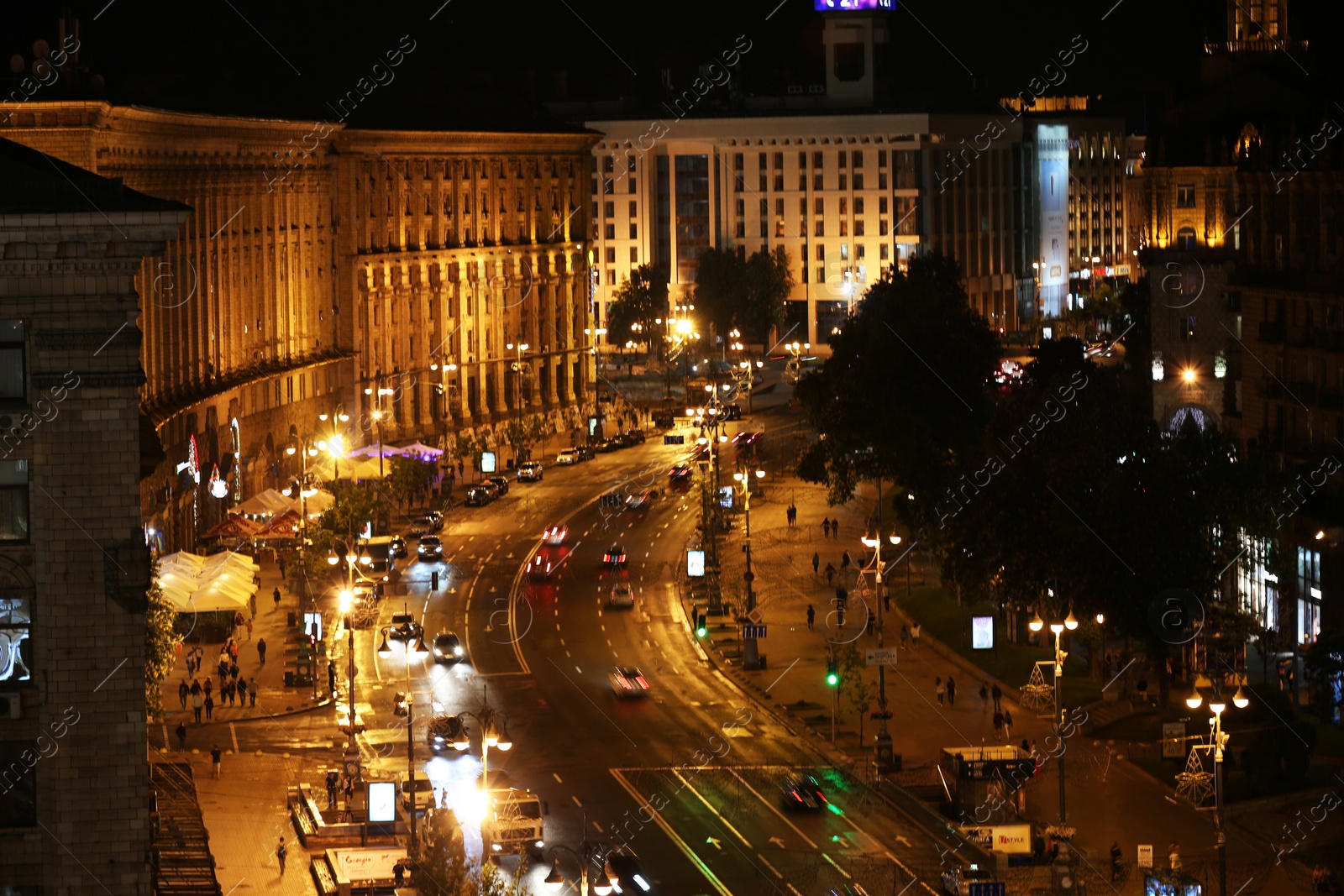 Photo of KYIV, UKRAINE - MAY 21, 2019: Night cityscape with illuminated buildings and street traffic