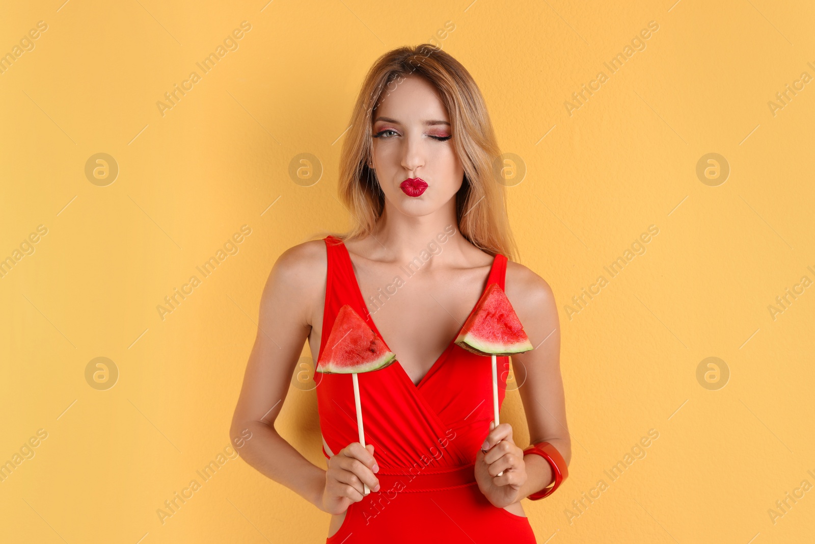 Photo of Pretty young woman with juicy watermelon on color background