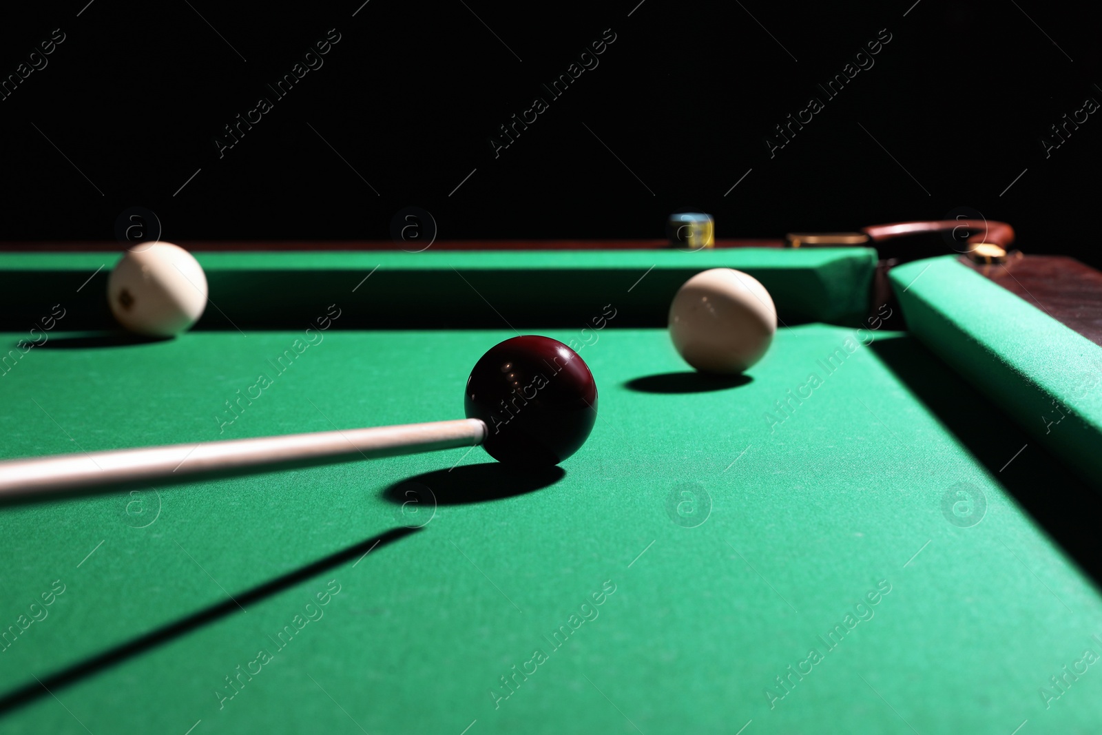 Photo of Striking red ball into billiard table pocket