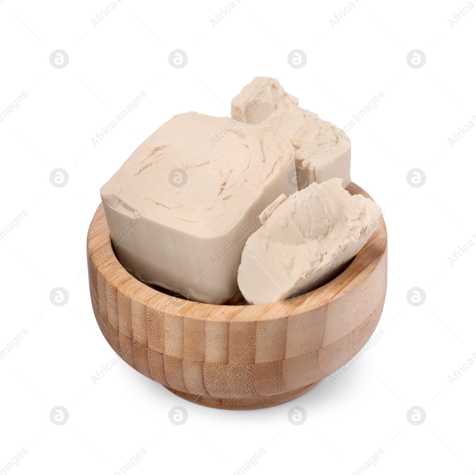 Photo of Pieces of compressed yeast in wooden bowl isolated on white