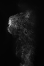 Photo of White steam column rising on black background