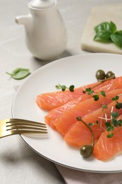 Delicious salmon carpaccio served on light grey table, closeup