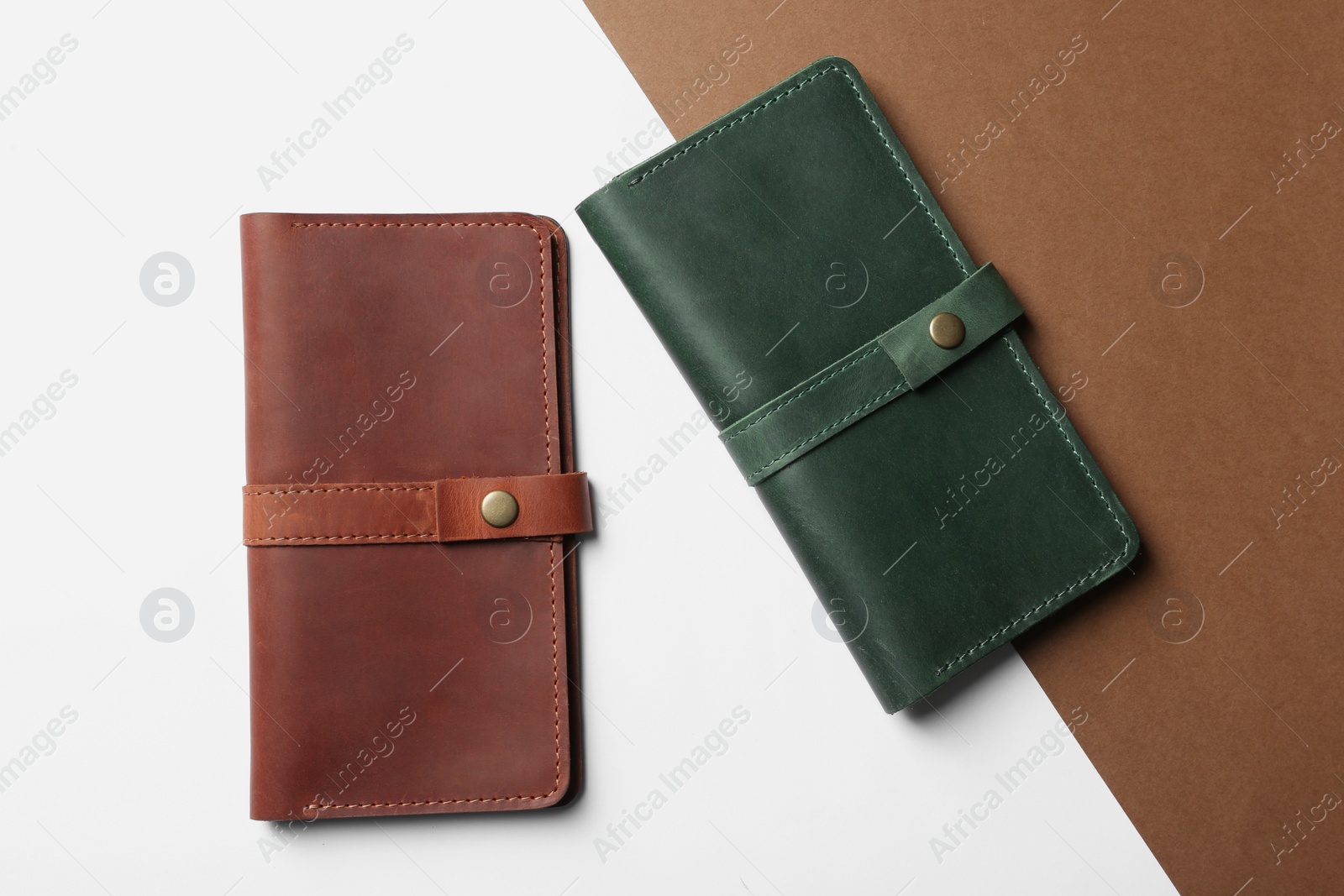 Photo of Stylish wallets on color background, top view