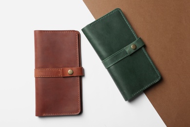 Photo of Stylish wallets on color background, top view