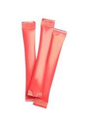 Red sticks of sugar on white background, top view