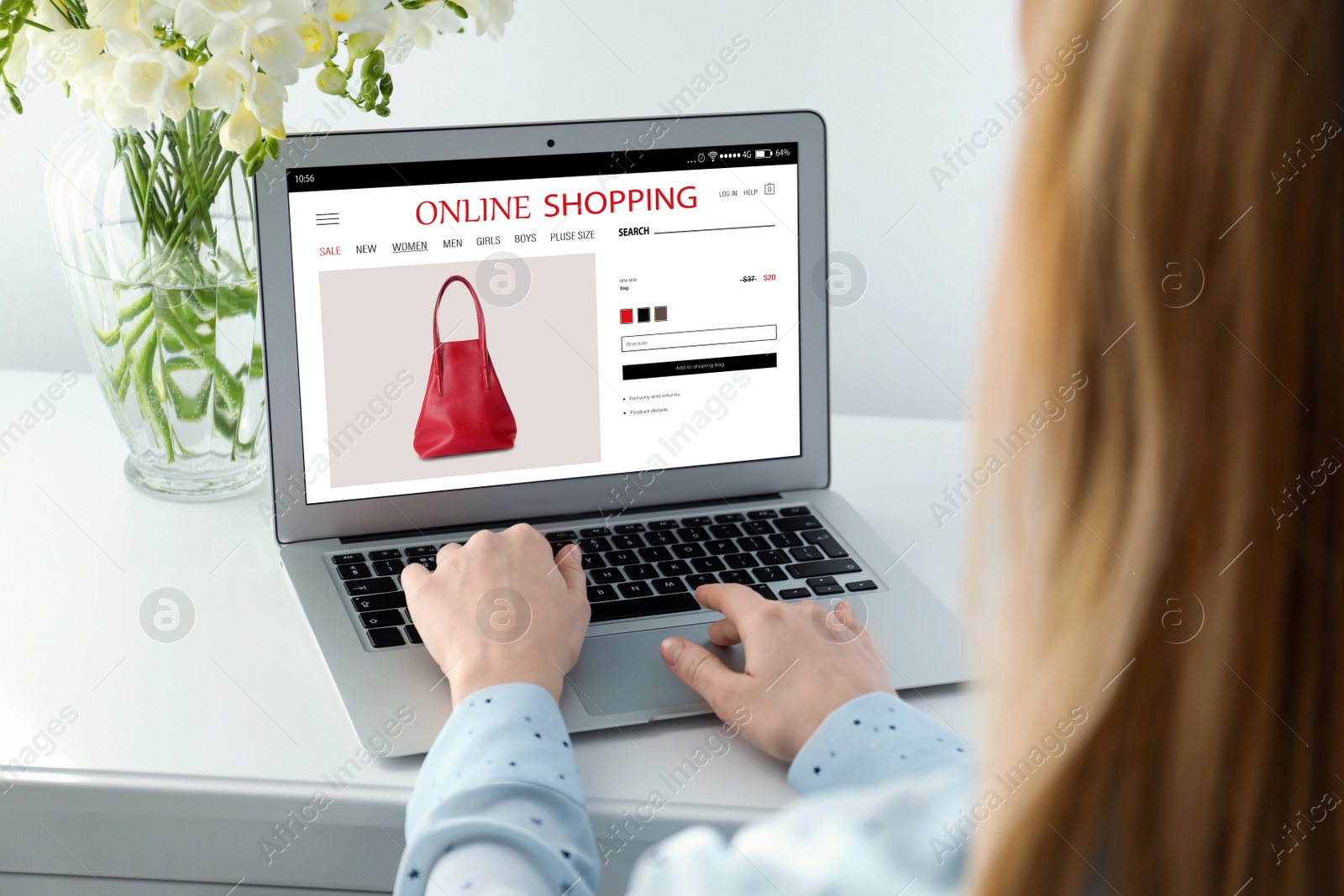 Image of Woman shopping online using laptop at table, closeup