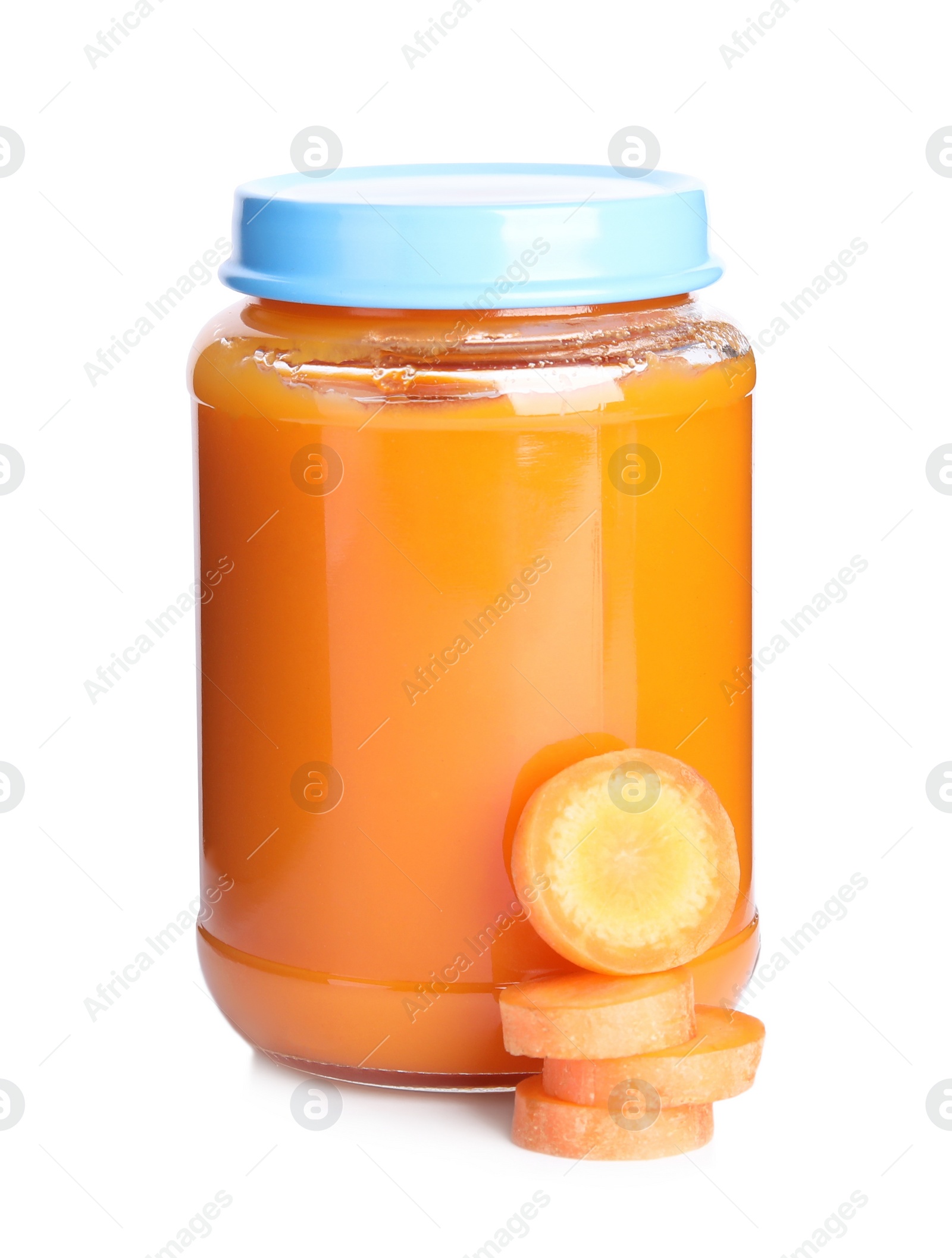 Photo of Jar with baby food and carrot slices on white background