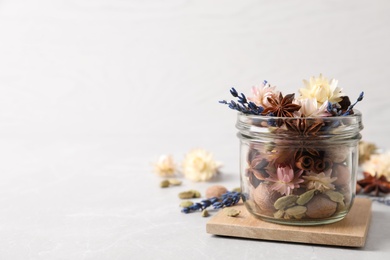 Photo of Aroma potpourri with different spices on white table, space for text