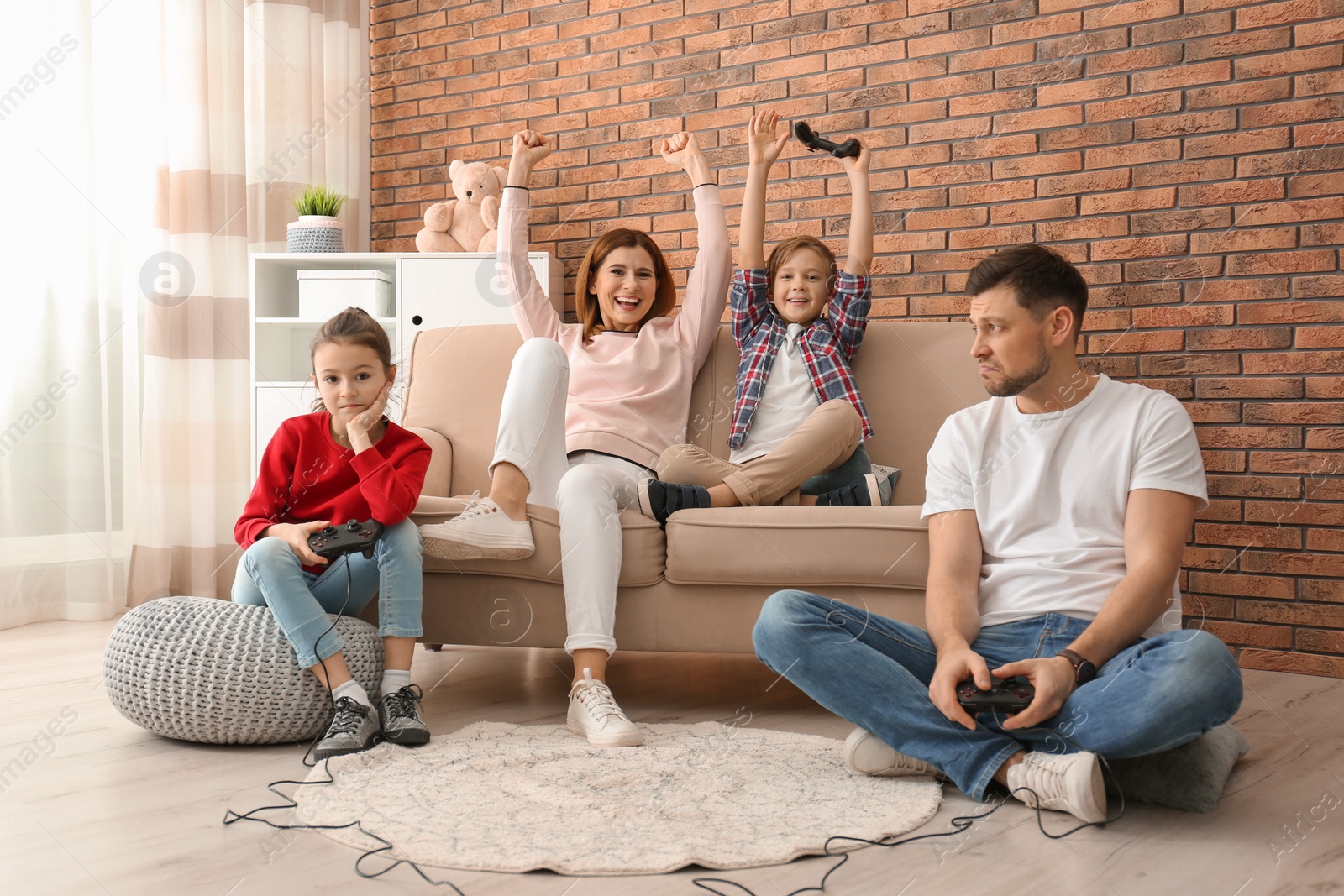 Photo of Happy family playing video games in living room