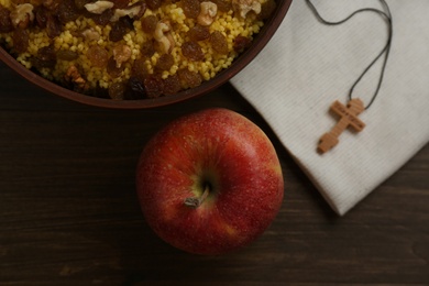 Photo of Flat lay composition with Great Lent dinner and crucifix on wooden table