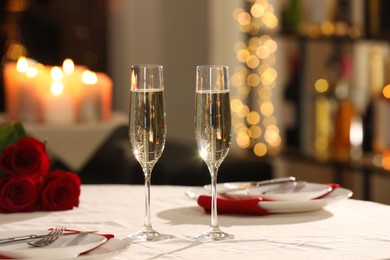 Photo of Romantic dinner table setting with glasses of champagne in restaurant