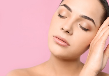 Portrait of young woman with beautiful face and natural makeup on color background, closeup. Space for text