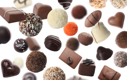 Image of Different chocolate candies falling on white background