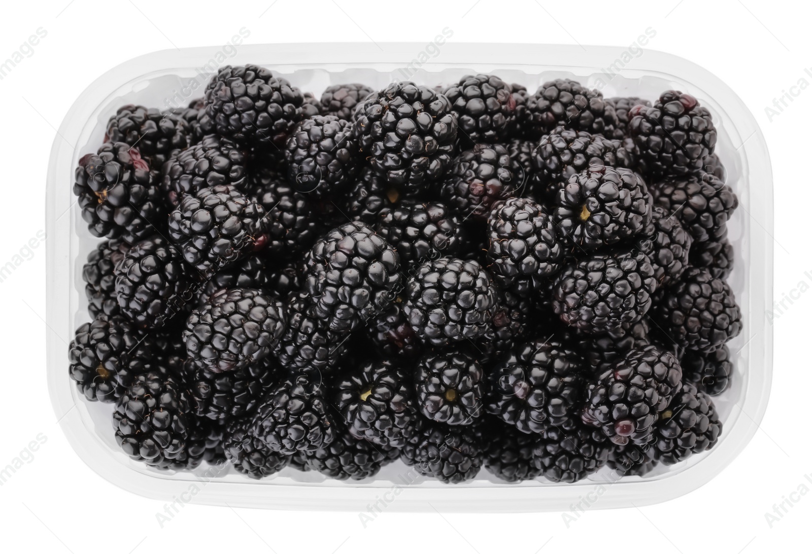 Photo of Tasty ripe blackberries in plastic container isolated on white, top view