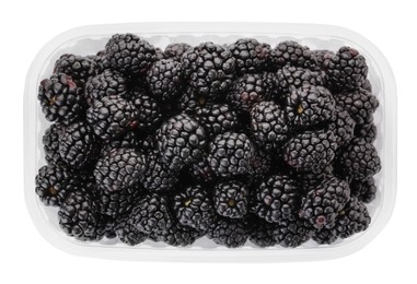 Photo of Tasty ripe blackberries in plastic container isolated on white, top view