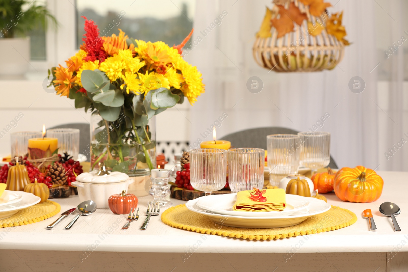 Photo of Autumn table setting with floral decor and pumpkins indoors