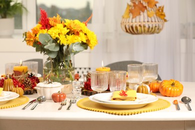 Autumn table setting with floral decor and pumpkins indoors