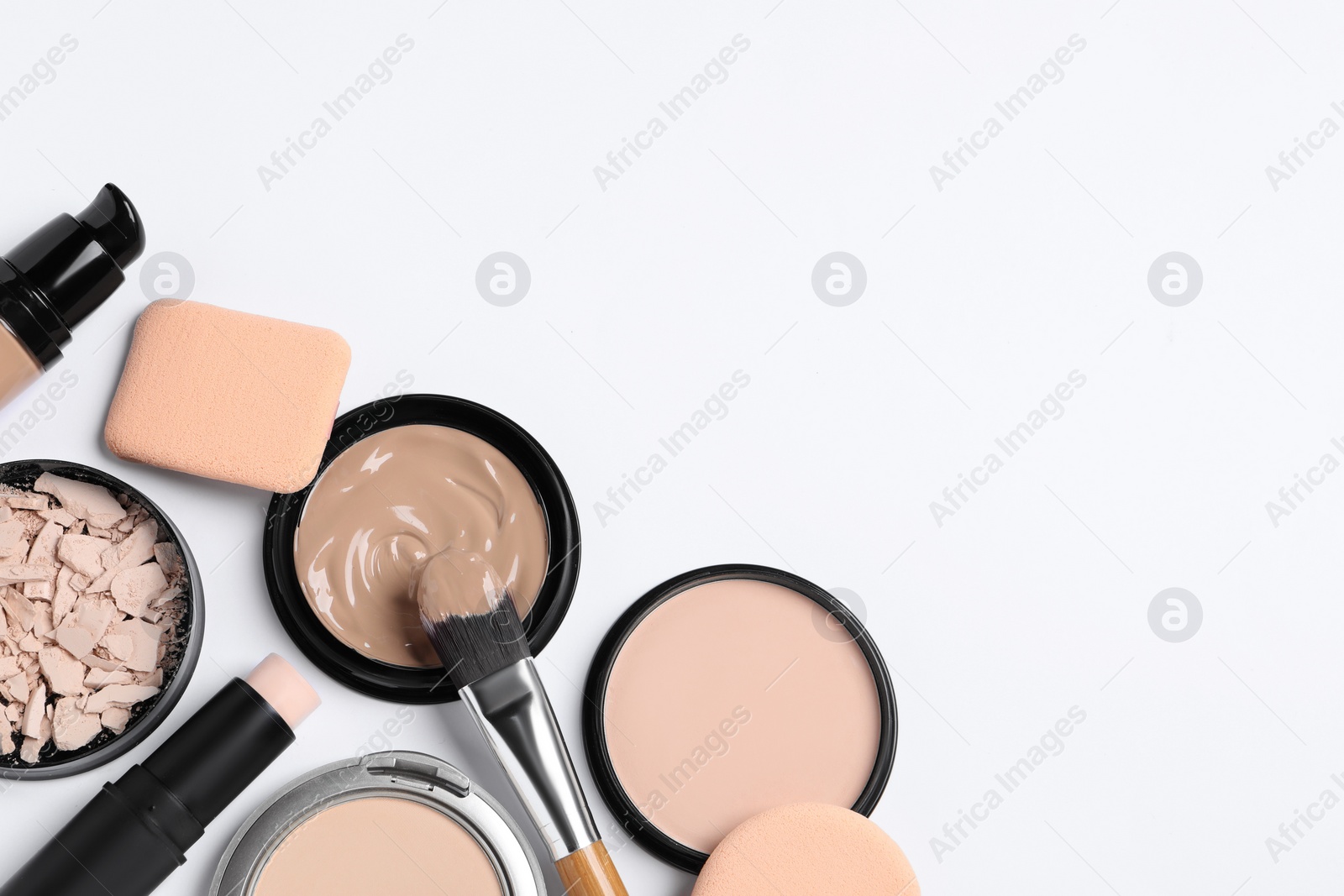 Photo of Foundation, beauty accessories and face powders on white background, flat lay. Space for text