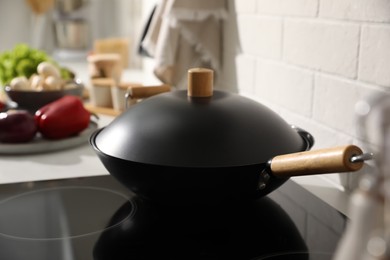 Photo of Frying pan with lid on stove in kitchen