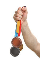 Man holding medals on white background, closeup. Space for design