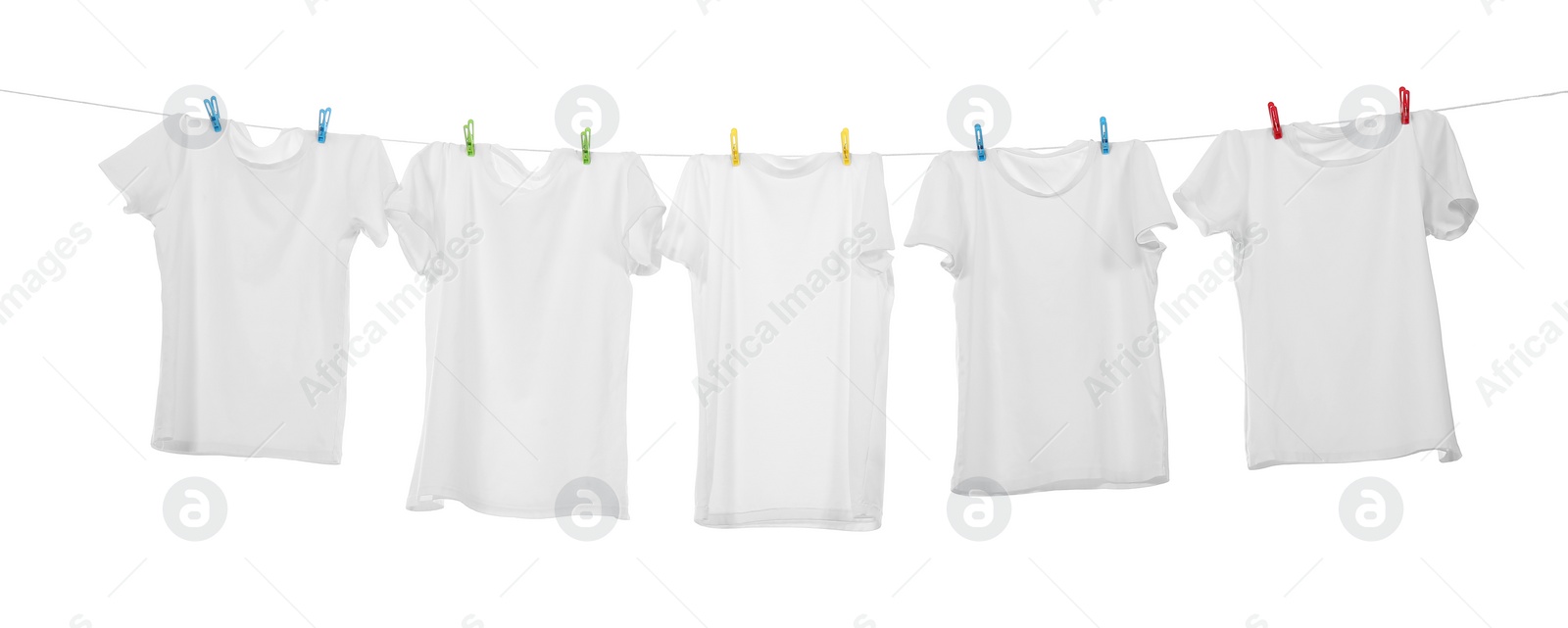 Photo of Many t-shirts drying on washing line isolated on white