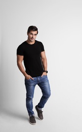 Photo of Full length portrait of handsome young man in casual clothes on grey background