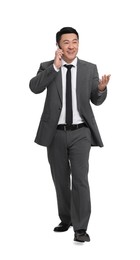 Businessman in suit talking on phone against white background