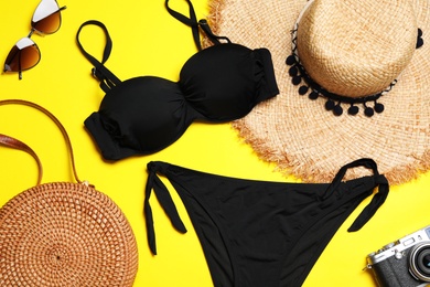 Flat lay composition with stylish bikini on color background. Beach objects