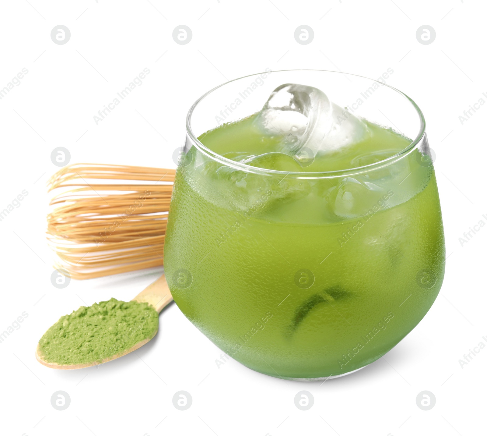 Photo of Glass of delicious iced green matcha tea, spoon with powder and bamboo whisk isolated on white