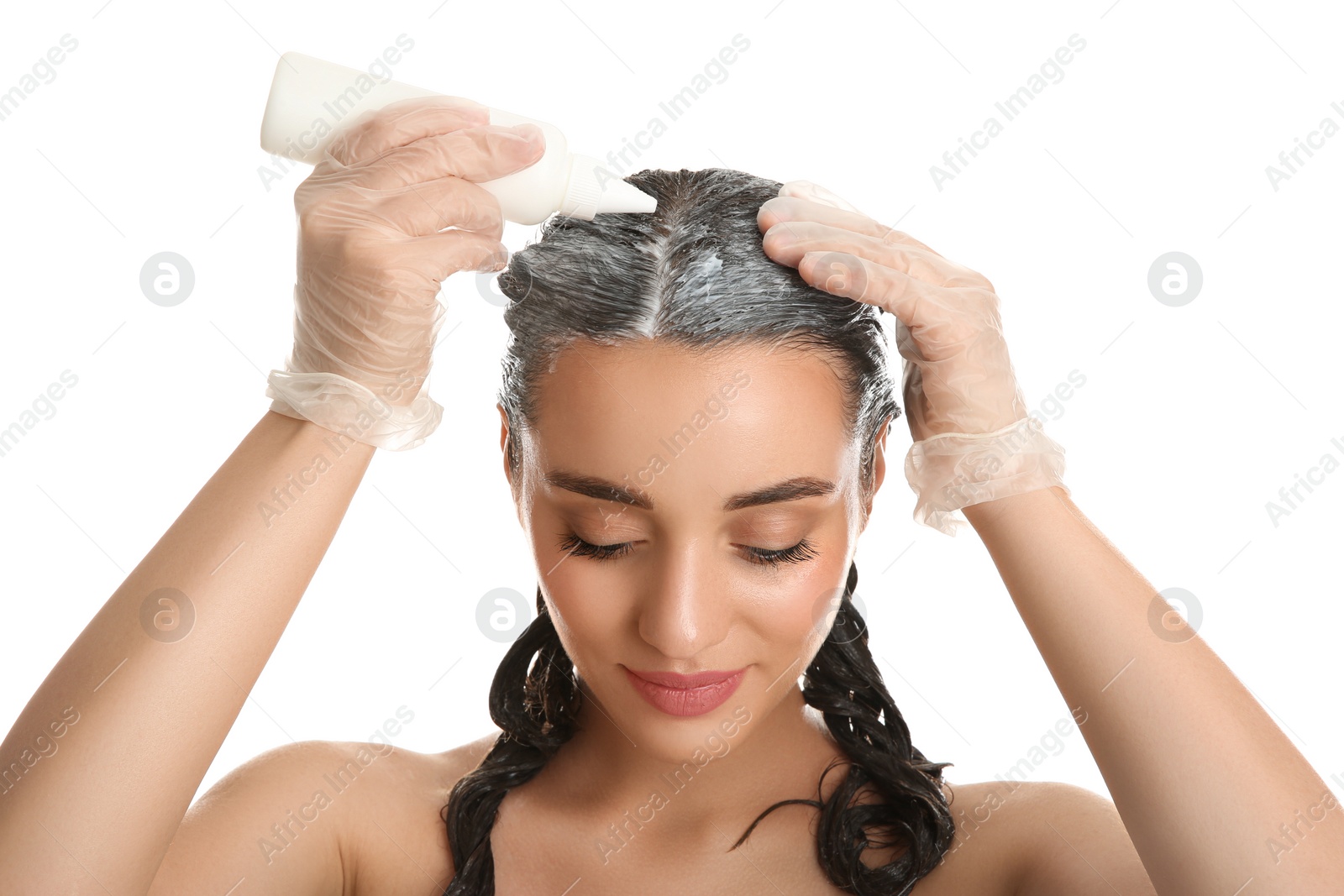 Photo of Young woman dyeing her hair against white background