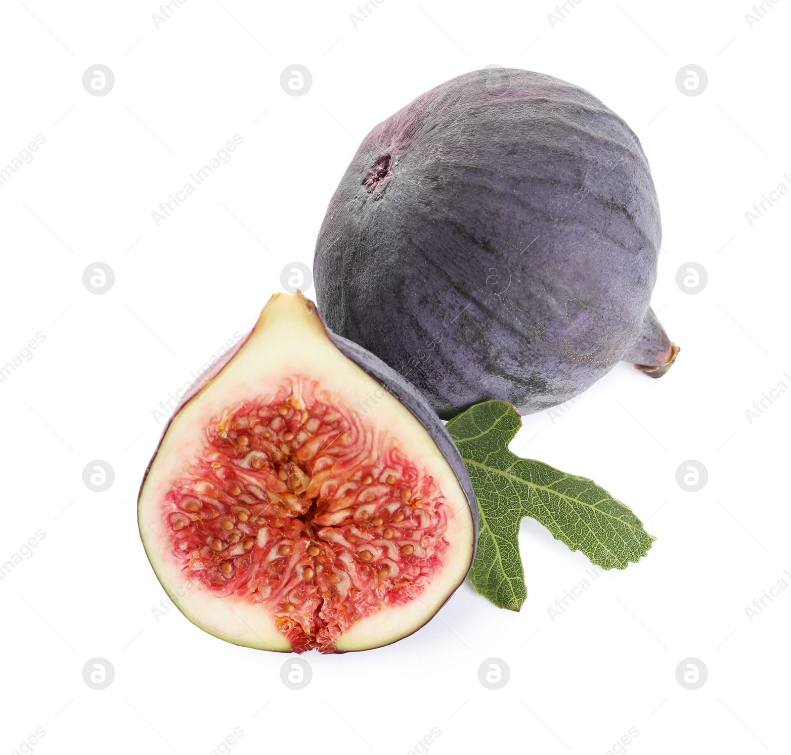 Photo of Whole and cut purple figs on white background