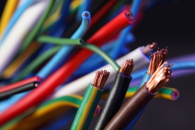 Photo of Colorful cables on blurred background, closeup. Electrician's supply