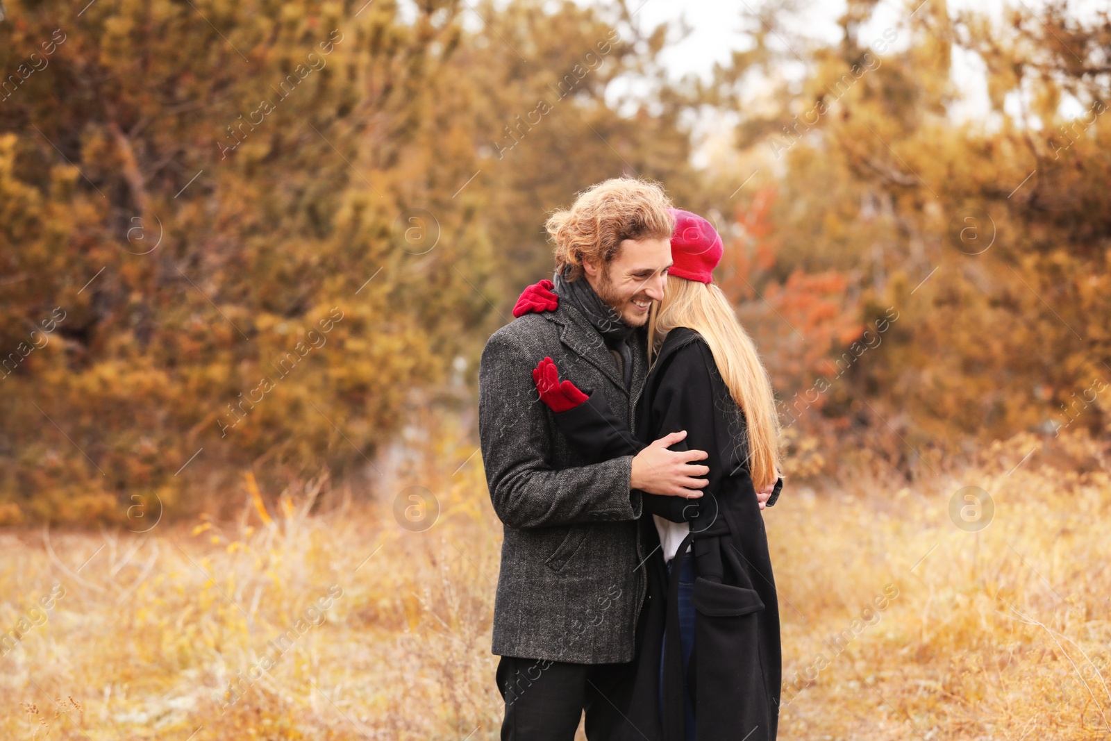 Photo of Young romantic couple in park on autumn day