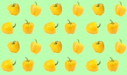 Image of Pattern of yellow bell peppers on light green background