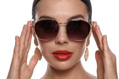 Photo of Attractive woman wearing fashionable sunglasses on white background, closeup