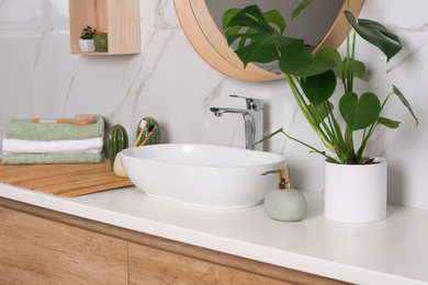 Photo of Stylish vessel sink on light countertop in modern bathroom