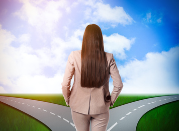 Image of Choose your way. Woman standing at crossroads taking important decision