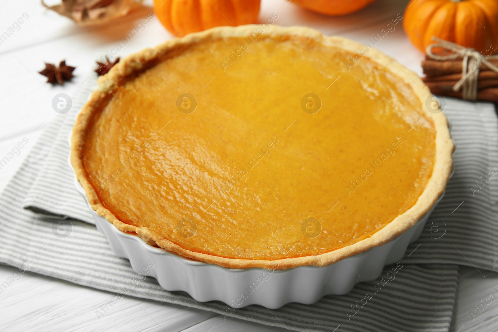 Photo of Delicious pumpkin pie on white wooden table, closeup