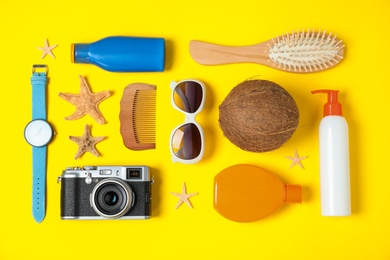 Photo of Flat lay composition with beach accessories on yellow background